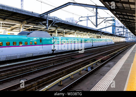 Utsunomiya, Giappone - Aprile 4, 2019: JR East Shinkansen bullet train da Tokyo in arrivo alla stazione della piattaforma con la gente seduta all'interno, linea gialla e r Foto Stock
