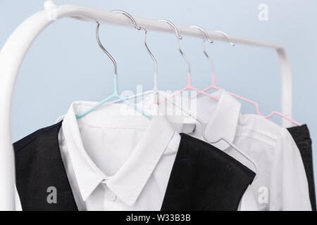 Elegante uniforme scolastica appeso sul rack, primo piano Foto Stock