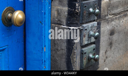 Un portale con una porta blu e antica porta le campane in un casamento di Edimburgo, Scozia, Regno Unito Foto Stock