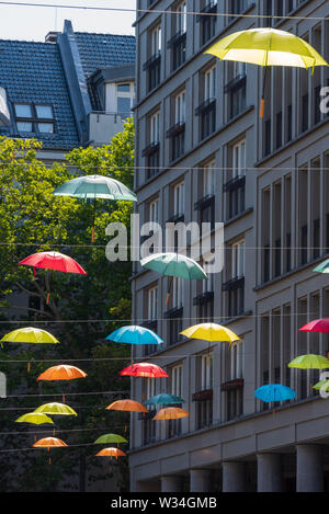 Ombrelloni colorati sospesi attraverso Walter Benjamin Platz a Berlino Foto Stock