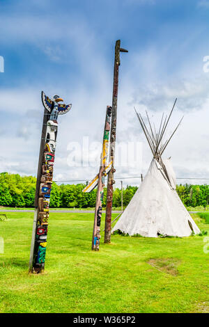 Avamposto di Wild West che mostra i tipi e i totem indiani nativi Foto Stock