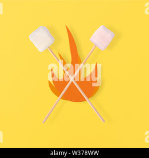 E deliziosi dolci marshmallows su stick sopra il falò su sfondo giallo Foto Stock