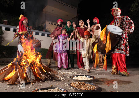 Famiglia che celebra il festival di Lohri, Punjab, India Foto Stock