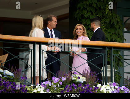 L'ex tennista Stefan Edberg (secondo, a sinistra) con Katherine Jenkins su un balcone su Center Court il giorno tredici dei campionati di Wimbledon all'All England Lawn Tennis and Croquet Club, Wimbledon. Foto Stock