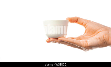 Donna tatuata mani tenendo un vasetto di crema di latte Foto Stock