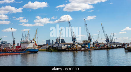 Logistica. Porto internazionale di Rotterdam Paesi Bassi, enormi gru, contenitori e nave, soleggiata giornata estiva Foto Stock