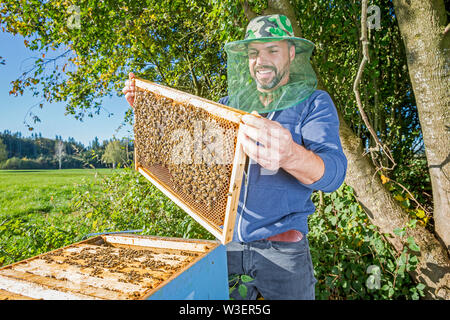 Ritratto di beekeper maschio con alveare Foto Stock
