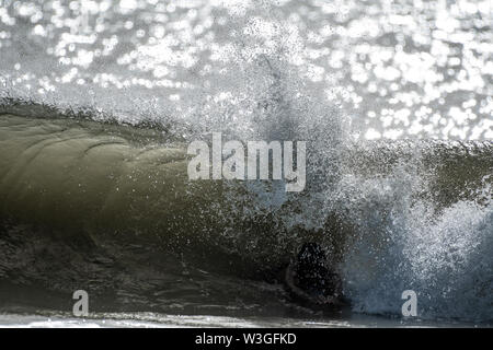 Sole di sera brilla sopra l'acqua Foto Stock