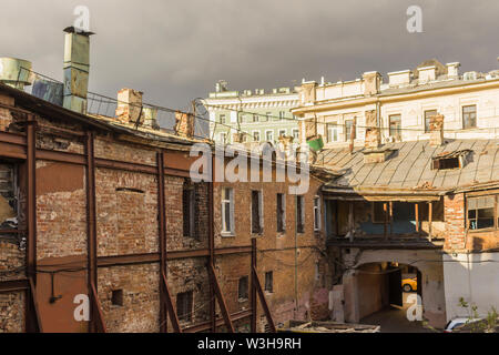 Il cortile interno del trimestre, che fu costruito nel XIX secolo. Tempo lungo senza riparazione. Vecchie mura, mattoni, windows, estensioni arch. Foto Stock