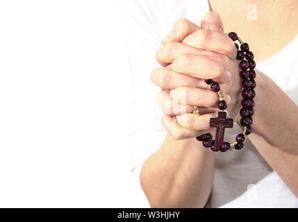 Donna che prega insieme a mano protesa con il crocifisso e il rosario croce immagine stock e stock photo Foto Stock