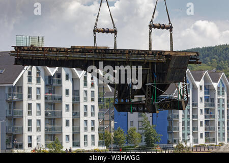 Nella foto: una gru solleva il ponte mobile su fiume Tawe nell'area Morfa di Swansea, Galles del Sud. Domenica 14 luglio 2019 Re: un anno 110 Old Bridge ha Foto Stock