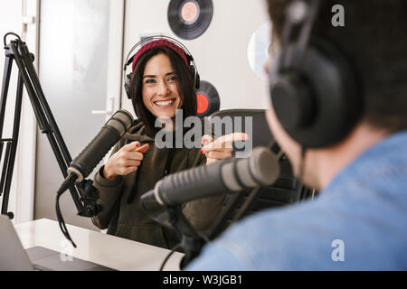 L uomo e la donna in camice bianco podcaster intervista a vicenda per la radio podcast Foto Stock