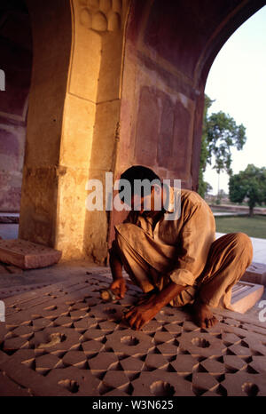 Un artigiano locale facendo lavori di restauro sul pavimento della moschea Badshahi, nell Arcidiocesi di Lahore, Pakistan. Costruito dall'imperatore Mughal Aurangzeb nel 1673, la moschea è uno dei migliori noto punto di riferimento della città e una grande attrazione turistica epitomizing la bellezza e la grandezza dell'era Mughal. Aprile 20, 2005. Foto Stock