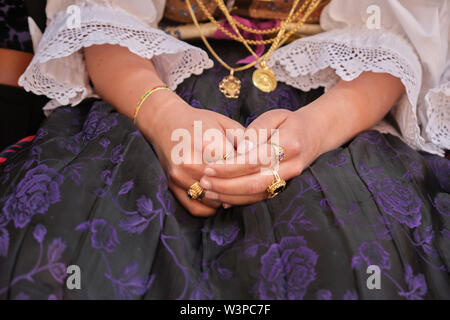 Una Donna vestita in tipico costume sardo con diverse ornamentali sardi gioielli d'oro. Tipico sardo. Foto Stock