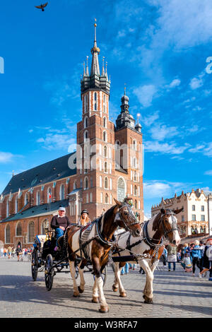 Carro trainato da cavalli nella piazza principale del mercato, Cracovia in Polonia Foto Stock