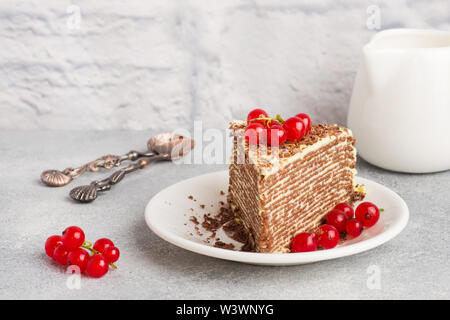 Torta di sottili frittelle di cioccolato e crema di pistacchio con rosse bacche Ribes Foto Stock