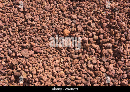 Immagine di sfondo di un pavimento texture di marrone pietre vulcaniche sotto la luce del sole Foto Stock