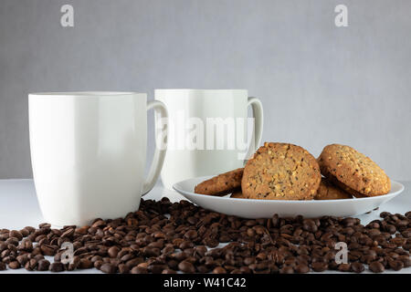 Caffè e biscotti. Il tempo per rilassarsi. Coppe di bianco con caffè e semi tostati. Foto Stock