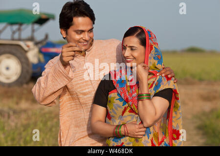 Uomo che dà orecchi a sua moglie Foto Stock