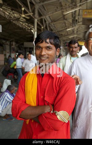 Portrait of a coolie smiling at a station platform Stock Photo