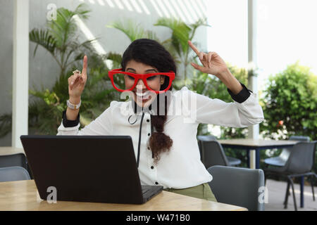 Woman wearing Comedy glasses and laughing Stock Photo