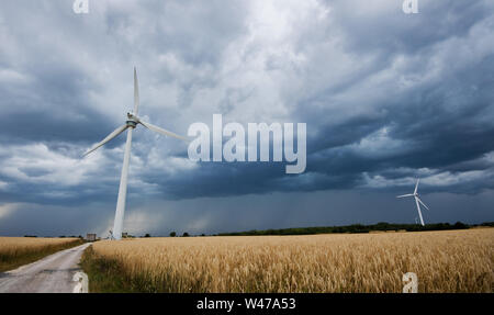 Hannover, Germania. Il 20 luglio, 2019. Una tempesta davanti è ampi attraverso un campo di turbine eoliche nella regione di Hannover. Credito: Julian Stratenschulte/dpa/Alamy Live News Foto Stock