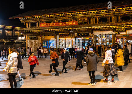 Shangri La, Cina - 28 Febbraio 2019: la gente ballare insieme tradizionale tibetana di Danze in Cerchio e a notte nel cuore di Shangri La città vecchia in Foto Stock