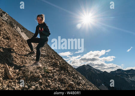 Sentiero femmina Runner scompone giù Yamnuska Mountain Foto Stock