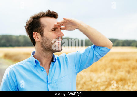 Ritratto di un giovane uomo felice guardando avanti Foto Stock