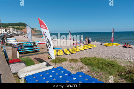 Sidmouth, Devon, Inghilterra, Regno Unito. Luglio 2019. Sidmouth un popolare resort per vacanze in East Devon. Noleggio e affitto di tavole a vela e kayak sulla spiaggia. Foto Stock