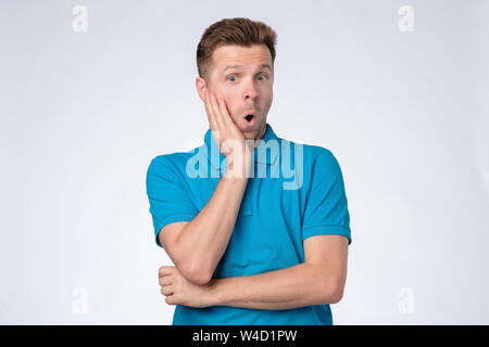 Sorpreso uomo aprì la sua bocca ampia con stupore. Foto Stock