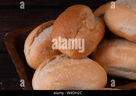 Panini nel cestino del pane su un sfondo di legno, chiave di basso, rustico Foto Stock