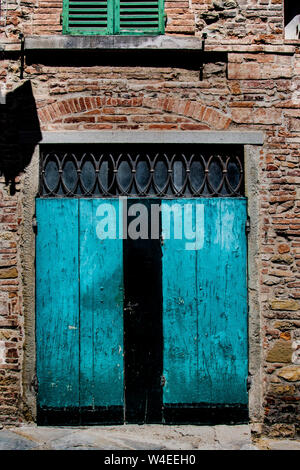 Scolpito a mano, antiquariato e ornati porta blu in Toscana, Italia Foto Stock