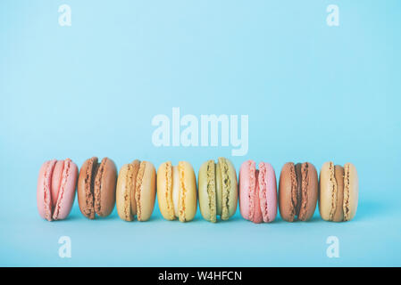 Macaron colorati su sfondo blu Foto Stock