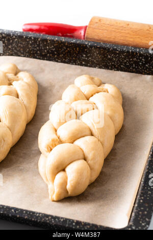 Cibo fatto in casa concetto processo risultava treccia di pane challah impasto su sfondo bianco con spazio di copia Foto Stock