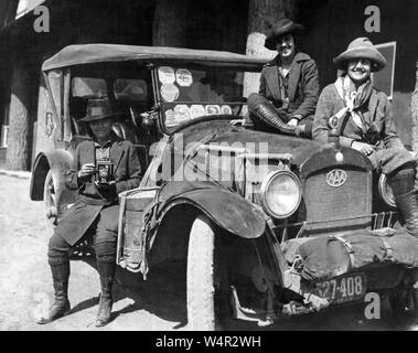 Autore e fotografo Maria Crehore Bedell (1870 - 1936) con i compagni di viaggio al Parco Nazionale di Yellowstone nel 1922. Il loro veicolo porta un certo numero di park adesivi sul parabrezza lungo con un motore AAA Club emblema sulla griglia. Bedell scrisse il libro, 'Moderne Zingari: la storia di un dodici mila motore miglio viaggio di campeggio che circonda gli Stati Uniti' che è stato pubblicato nel 1924. Foto Stock