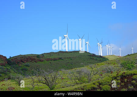 Fila di potenza elettrica mulini a vento sulla cresta Kealaloloa oltre Maalaea in Maui, Hawaii Foto Stock