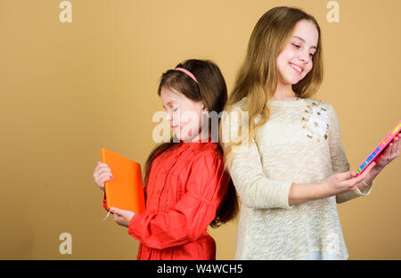 I ragazzi ragazze con libri e quaderni. Educazione e letteratura per bambini. Favola preferita. Sorelle pick libri da leggere insieme. Adorabili ragazze amano i libri. Diari segreti o un diario personale. Smart è grande. Foto Stock