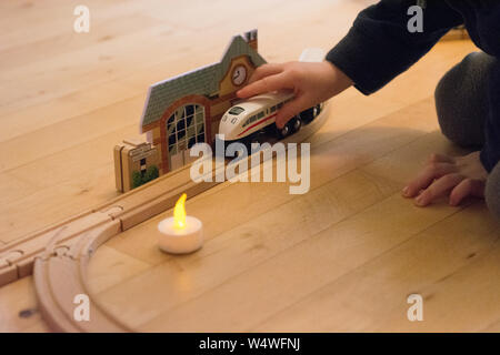 Giocare con un BRIO treno su un pavimento di legno Foto Stock