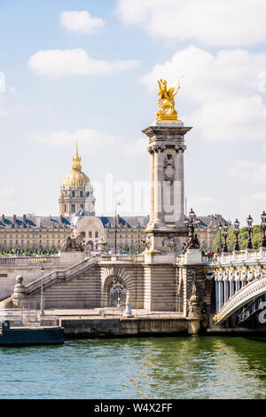 Il pont Alexandre III sul fiume Senna a Parigi, Francia, con la cupola des Invalides in background su una soleggiata mattina d'estate. Foto Stock