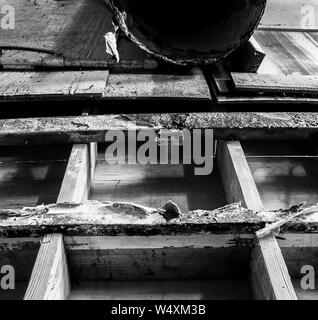 Dettaglio di decadere in legno e muro di stagno in industriali abbandonati cannery magazzino a Monterey in California. Bianco e nero testurizzato rustico dell'immagine. Foto Stock