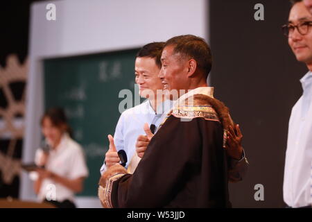 Ma Jack Yun, sinistra, presidente del gruppo Alibaba, pone con un villaggio docente alla cerimonia di presentazione del 2018 Insegnante rurale Premi lanciato da J Foto Stock