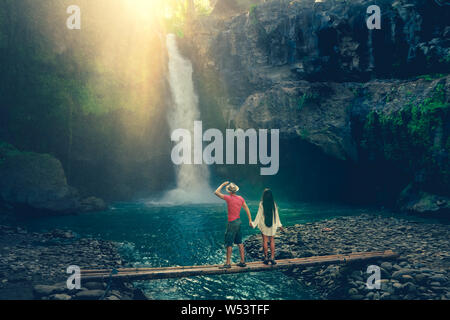 Uno stile di vita attivo giovane godere di sunrise incredibile cascata Tegenungan nascosti nella foresta pluviale tropicale Jungle Island Bali, Indonesia Foto Stock