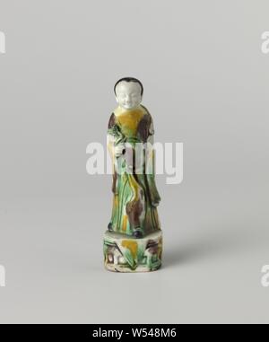 La figura di una donna tenendo un fiore, l'immagine di una donna su un piedistallo di porcellana dipinta su biscotti in verde, giallo, la melanzana e il nero. L'immagine mostra una donna in piedi con un fiore nella mano destra. Email sur biscotto., anonimo, Cina, c. 1700 - c. 1724, Qing-dinastia (1644-1912) / Kangxi-periodo (1662-1722) / Yongzheng-periodo (1723-1735), porcellana (materiale), smalto, vetrificazione, h 13.2 cm l 3,9 cm × w 2,9 cm Foto Stock