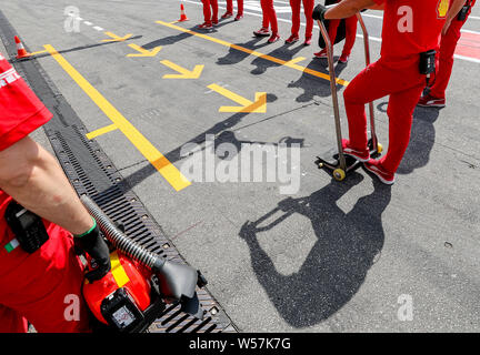 Hockenheim, Germania. 26 Luglio, 2019. Motorsport: il Campionato del Mondo di Formula 1, il Gran Premio di Germania. I meccanici del team Scuderia Ferrari sono in attesa davanti ai box per un pit-stop. Credito: Jan Woitas/dpa-Zentralbild/dpa/Alamy Live News Foto Stock