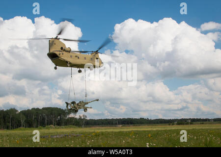Soldati con batteria C, 1° Battaglione, campo 194th reggimento di artiglieria, 2° brigata di fanteria Team di combattimento, 34a divisione di fanteria, Iowa l esercito nazionale Guard (IANG), per preparare una imbracatura operazione di carico durante un combattimento esportabile capacità di formazione (XCTC) rotazione a Camp Ripley, Minn., il 17 luglio 2019. Più di 3.800 soldati IANG partecipano al giorno 21-esercizio che addestrare soldati in dinamico e scenari difficili, comprese le operazioni notturne e live-fire esercizi. (U.S. Esercito nazionale Guard foto di Spc. Zachary M. Zippe) Foto Stock