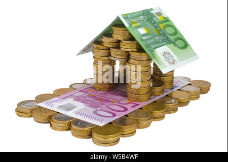 Casa modello costruito con banconote e monete metalliche in euro Foto Stock