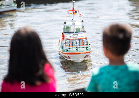 Wilhelmshaven, Germania. 28 Luglio, 2019. Due bambini di guardare a un modello di un DGzRS barca al giorno del salvataggio in mare dei soccorritori della società tedesca per il salvataggio dei naufraghi. Credito: Mohssen Assanimoghaddam/dpa/Alamy Live News Foto Stock