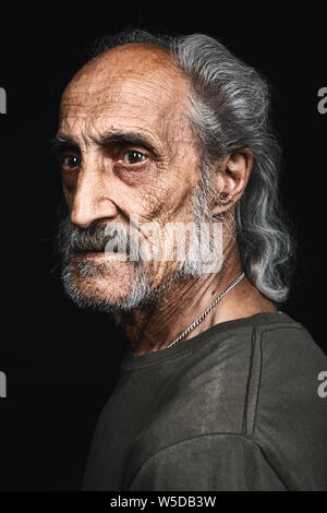 Profilo di senior uomo con i capelli grigi e grassetto con espressione seria. close up vista laterale verticale.La filosofia di vita. senilità concetto declino. Foto Stock