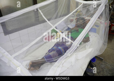 Dacca in Bangladesh. Il 28 luglio 2019. Un uomo coperto con una zanzariera soffre di febbre dengue come egli riceve il trattamento all'interno della 'haheed Suhrawardy' collega medico ospedale a Dhaka, Bangladesh, 28 luglio 2019. La dengue ha avuto una grave trasformare questo anno con un totale di 10,528 persone ottenere infettate con la zanzara per malattie finora. Questo è il numero di record di pazienti infetti con la malattia negli ultimi 18 anni in Bangladesh, secondo i dati della direzione generale di assistenza sanitaria. Credito: ZUMA Press, Inc./Alamy Live News Foto Stock